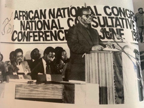 Oliver Tambo is seen speaking at the African National Congress (ANC) conference in the town of Kabwe, Zambia in 1985. At this time, the state of unrest and political violence in South Africa was reaching new heights. International pressure against the government was also growing. As acting President of the ANC, Tambo made two appeals. The first was to make South Africa ungovernable, intensify popular mobilisation and the armed struggle and strengthen international sanctions. The second was to ensure that the ANC was prepared with a clear constitutional vision of a new South Africa if conditions for negotiations were created. Tambo received a mandate to pursue both strategies. Umsebenzi, the mouthpiece of the South African Communist Party spoke of the spirit of unity and sense of forward momentum that the conference created.