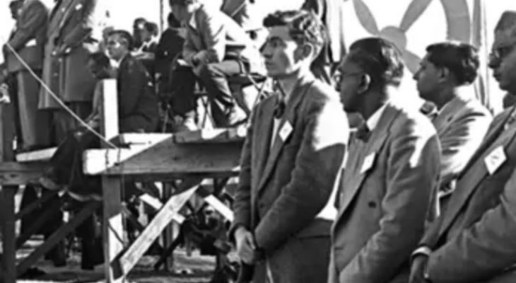 Podium at Congress of the people, Kliptown, with Albie Sachs and others in the foreground.